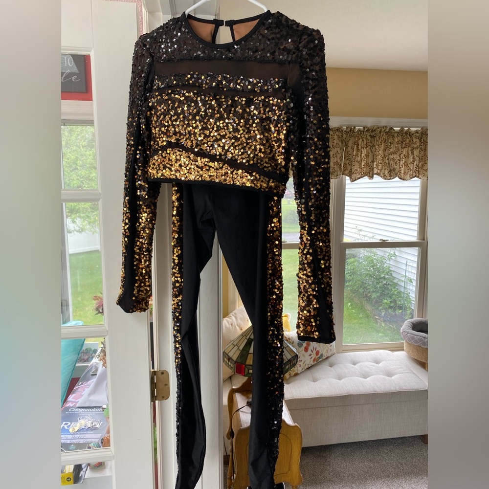 Medium Adult two-piece black and gold costume.